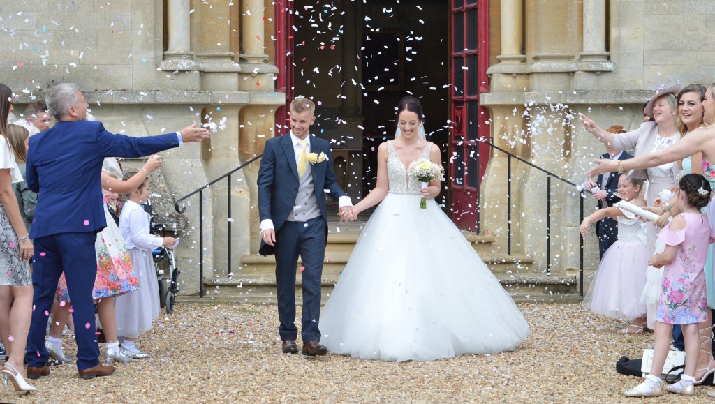 UK wedding photography , Bride and groom confetti leaving church